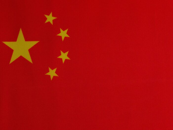 a close up of a red background with yellow stars